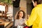 Waitress giving packaged boxes to deliver boy