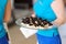 Waitress holding a dish of cupcakes