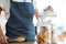 Waitress holding jar and tong in cafÃƒÂ©