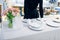 Waitress puts dishes for banquet, table setting
