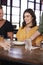 Waitress Serving Couple Meeting For Drinks And Food In Restaurant