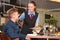 Waitress serving the meal to guest in restaurant