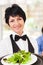 Waitress serving salad