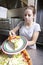 Waitress serving a slice of all dressed pizza