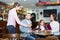 Waitress taking table order at cafe