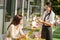 Waitress taking woman\'s order at cafe bar