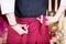 Waitress Tying Apron In Restaurant