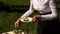 A waitress in uniform arranges appetizers on plates.