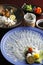Wakasa blowfish or fugu thin fillet in big platter with lemon, s
