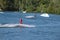 Wake-boarders and sky water touch down after an jump at Cergy water amusement park, France