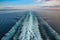 Wake of a ship across Ocean while sailing into the Norwegian fjords, on a beautiful day.