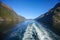 Wake of the ship while scenic cruising down Geiranger fjord. Beautiful landscape with mountains, Norway.