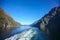 Wake of the ship while scenic cruising down geiranger fjord. Beautiful landscape with steep cliffs, Norwegian fjords, Norway.