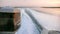 Wake and waves and close up of an outboard engine in coastal waters at sunset with marsh grass in the background