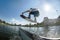 Wakeboarder jumps at ramp at wake park