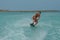 Wakeboarder Leaning into a Turn on a Wakeboard in Aruba