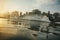 Wakeboarder skiing on lake at sunset