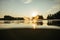 Wakeboarder skiing on lake at sunset