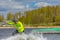 Wakeboarder on wakeboard landed in water surrounded by splash. Wakeboarding is an extreme sport