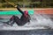 Wakeboarding. Girl wakeboarder falls into the water after an unsuccessful jump