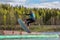 Wakeboarding. Teen Wakeboarder makes extreme Jump in air on wakeboard. Girl flies in the sky