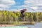 Wakeboarding. Teen Wakeboarder makes extreme Jump in air on wakeboard. Girl flies in the sky