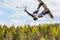 Wakeboarding. Teen Wakeboarder makes extreme Jump in air on wakeboard. Guy hanging in the air upside down