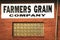Wakita Oklahoma USA - Farmers Grain Company sign above glass block window in brick building with messy wires