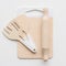 Waldorf toys on white background. Wooden rolling pin, spatulas and cutting board