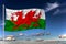 Wales national flag waving in the wind against deep blue sky.  International relations concept