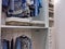 Walk in closet with clothes hanging and shoes on shelving