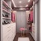 A walk in closet with a pink chair