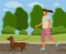 Walk with dog in the park. Girl is going with a rinning dachshund doggy in garden sunny day