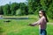 Walk with a drone. A woman in black glasses launches a low flying drone into the air, catches a flying drone .