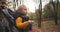 Walk of mother and toddler in pram in autumn park, calm weekend at nature, closeup portrait of baby