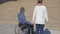 Walk in park invalid on wheel chair and girlfriend, Couple lovers