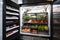 walk-in refrigerator with shelves stocked with fresh fruits, vegetables, and meats