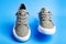 Walk shoes. Modern unisex footwear, sneakers isolated on blue background. Fashionable stylish sports casual shoes