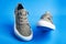 Walk shoes. Modern unisex footwear, sneakers isolated on blue background. Fashionable stylish sports casual shoes