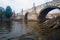 Walk on a sightseeing boat on the Vltava River past Charles Bridge in Prague, Czech Republic