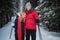 A walk in the spruce forest on skis brings joy and happiness to a young married couple of skiers