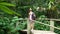 Walk to the waterfall along the path in the rainforest. Bali, Indonesia.