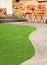 Walk way with Perfect grass landscaping with artificial grass in residential area