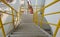 Walk way with yellow handrail inside factory