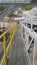 Walk way with yellow handrail in side of Stone Belt conveyors