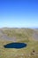 Walker on Blencathra looking at Scales Tarn