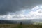 A Walker in the Peak District as the weather turns and the dark clouds roll in