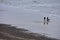 Walkers on Beach and North Sea, Overstrand, Cromer, Norfolk, UK