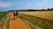 Walkers on the path heading to Blakeney from Morston Quay Norfolk.