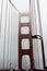 Walking across the Golden Gate Bridge on a very foggy day with the towers shrouded in fog, San Francisco, California